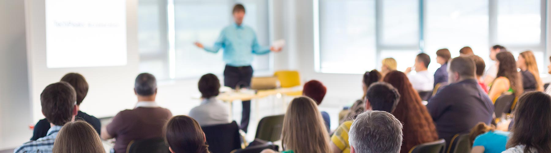 man giving presentation to a large room of people